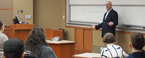 Photograph: Michael Burbach discussing securities and financial regulation with students.